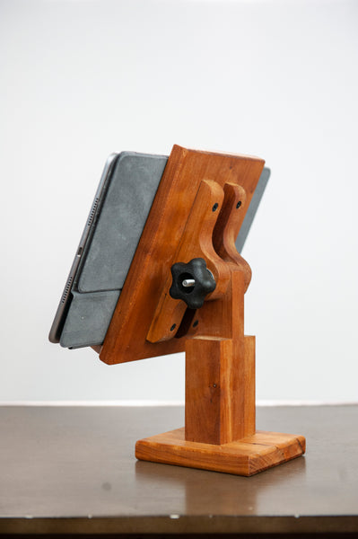 Adjustable wood tablet stand from the back, with an ipad on a white background.