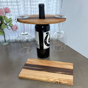 Wood Wine and Glass Display with a coordinating cheese board on a grey table and white window background