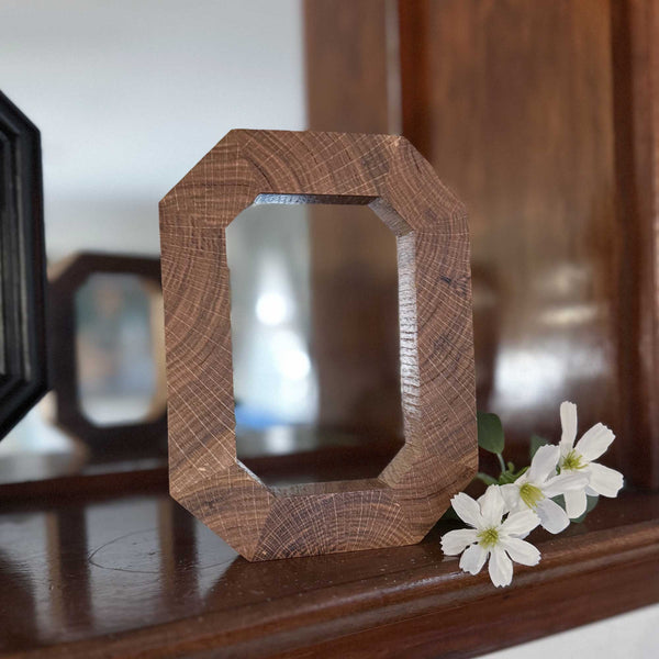Solid wood Block O in front of mirror 