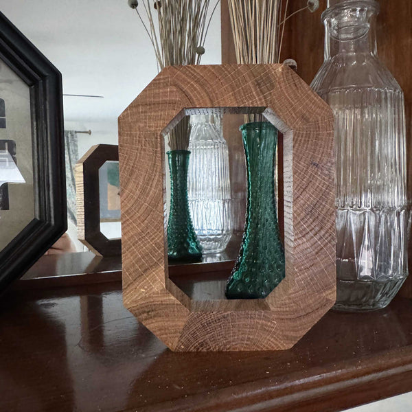 Solid wood Block O in front of mirror 