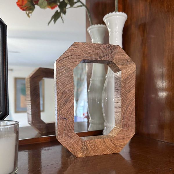 Solid wood Block O in front of mirror 
