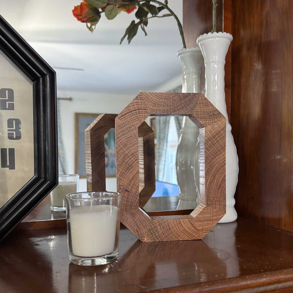 Solid wood Block O in front of mirror 