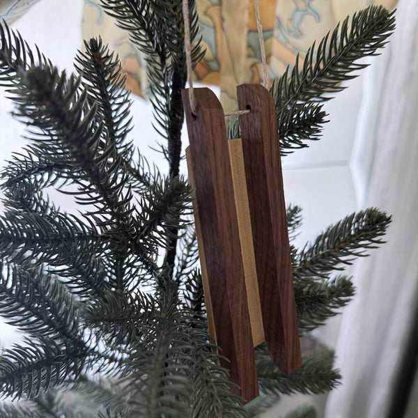 Back of wooden sled ornament hanging on a Christmas tree
