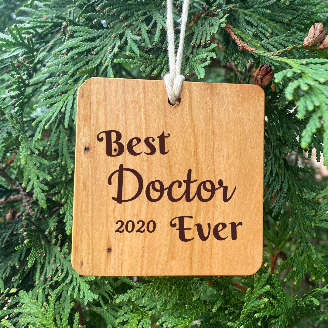 Best Doctor Ever Ornament on pine tree background.
