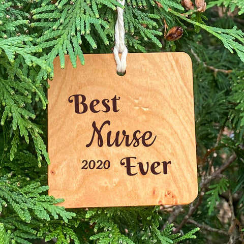 Best Nurse Ever Ornament on Pine Tree Background.