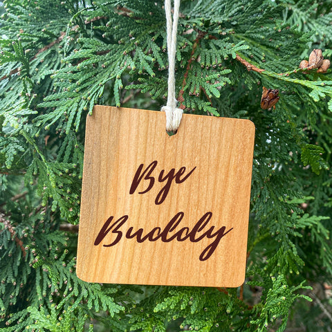 Bye Buddy the Elf Ornament on green pine tree background