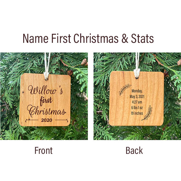 First Christmas & Stats wood ornament. Two ornaments hanging side by side on a pine tree, the front with first Christmas. The back laser engraved birth stats.