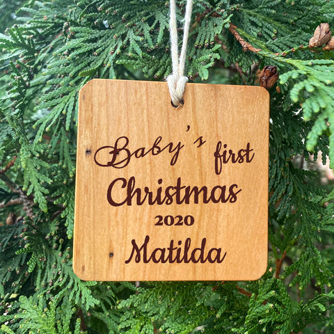 Baby's First Christmas Ornament on Pine Tree Background