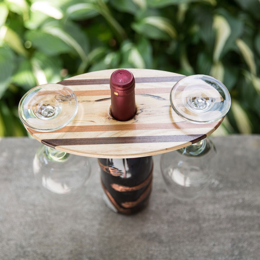 Wood wine display shown from the top, two wine glasses hanging with a wine bottle in the middle.