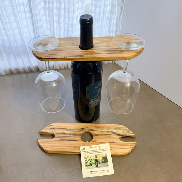 Wood wine display with natural wood grain. Two glasses and wine bottle. 